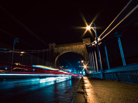bridge at night with vehicles light trailsの写真素材