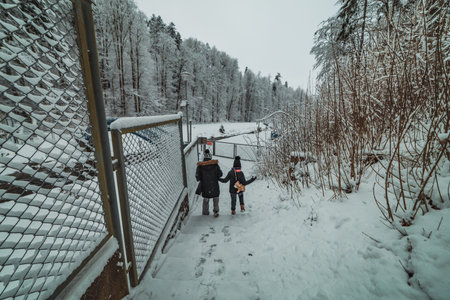 people by the snow-covered damの写真素材