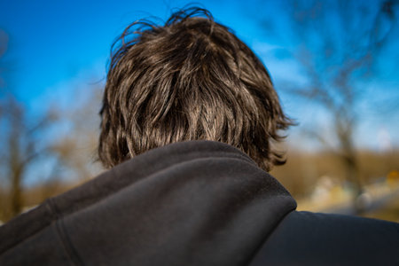 head of man in hooded sweatshirt seen from behindの写真素材
