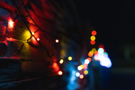 Colorful lights on brick wall. Bokeh background.