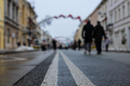 City street with people walking on the street. Blurred background.