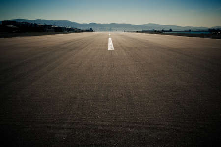 Runway of the Gibraltar airport in the evening. Photo with strong vignette and retro color grading.の写真素材