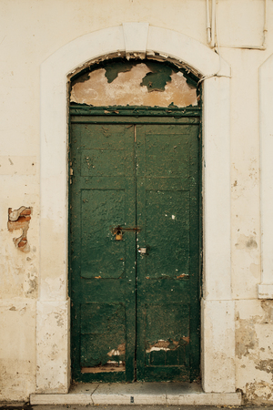 Old green wooden door in old abandoned building in Gibraltar.の写真素材