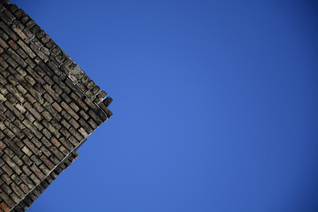 Old brick wall on a background of blue skyの写真素材