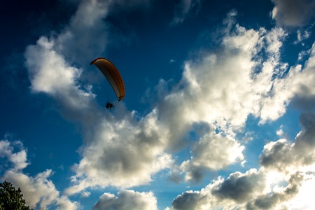 Paraglider on a background of the cloudy sky