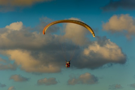 Paraglider on a background of the cloudy sky