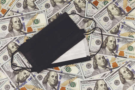 Protective mask on the background of 100 US dollars banknotes