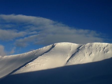 Snow-covered mountains  Kuluar closed on the right  The sun On the right shines and creates a shade in ÐºÑÐ»ÑÐ°Ñ  Over cloud mountain  The avalanche downhill will soon descendの写真素材