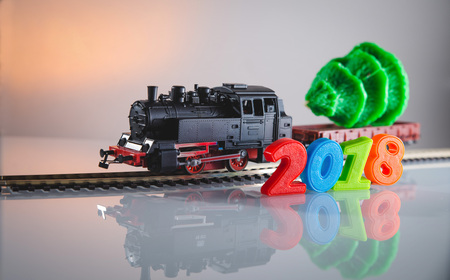 New Year 2018 and Santa Claus in a toy train with gifts, snowman and Christmas tree.の写真素材