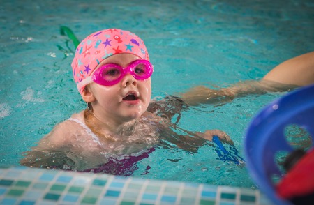 Little girl swimming in pool.の写真素材