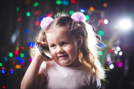 little baby with old vintage phone on retro backgroundの写真素材