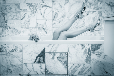 Seductive woman taking relaxing bath in her hot tubの写真素材