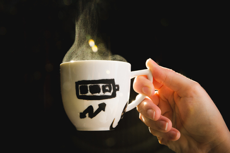 Coffee cup measuring energy level in Spanishの写真素材