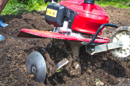 Man working in the garden with Garden Tillerの写真素材