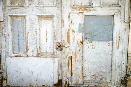 Countryside scene. Rustic old wooden gate in brick wall.の写真素材