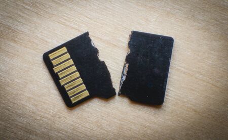 Broken destroyed micro sd card on white surface