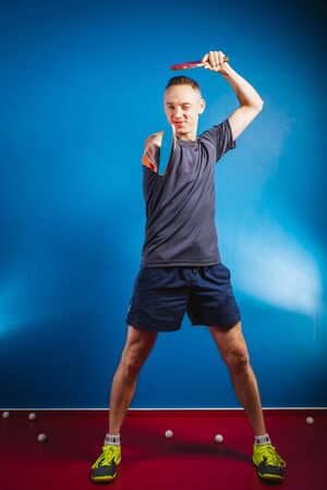 young man playing small tennis against a grunge backgroundの写真素材