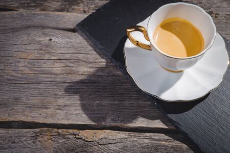 Cup of fresh espresso and roasted coffee beans on dark wooden backgroundの写真素材