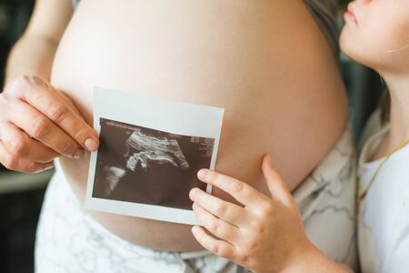 Mother playing and drawing with her baby daughterの写真素材