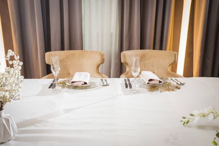 A very nicely decorated wedding table with plates and serviettes.の写真素材