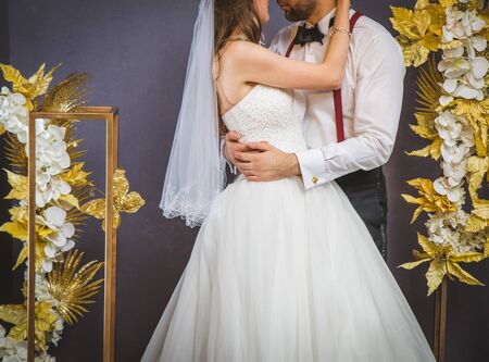 groom and bride kissing inside wedding marqueeの写真素材