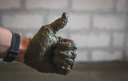 Man plastering a brick wall, restoration.