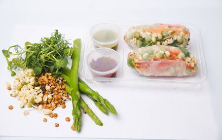 Baked salmon garnished with asparagus and tomatoes with herbsの写真素材