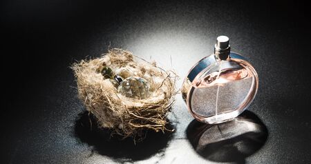 Perfume in a golden beautiful bottle on golden beadsの写真素材