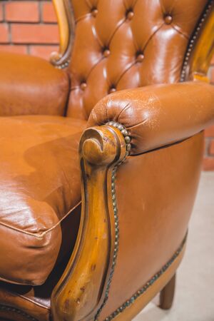 Antique armchair furniture with cushion against white wallの写真素材