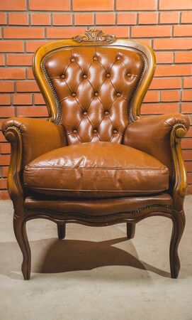 Antique armchair furniture with cushion against white wallの写真素材