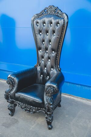 Antique armchair furniture with cushion against white wallの写真素材