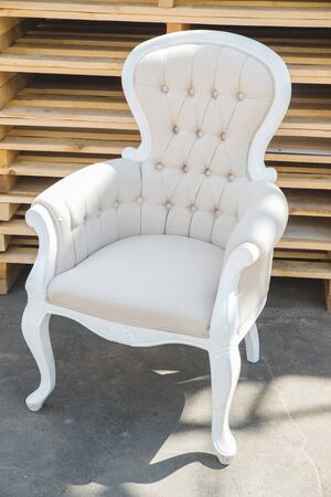 Antique armchair furniture with cushion against white wallの写真素材