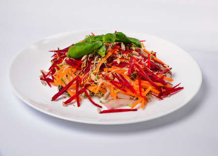 Arugula sprouts cut for salad in a wooden plate on the old rustic table. Micro greens full of vitamins and freshnessの写真素材
