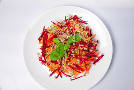 Arugula sprouts cut for salad in a wooden plate on the old rustic table. Micro greens full of vitamins and freshnessの写真素材