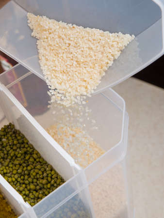 A large selection of bulk dry foods in clever dispensers and a weighing scale at an upscale grocery storeの写真素材