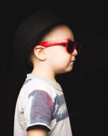 fashionable kid in summer park. fashion kid with glassesの写真素材