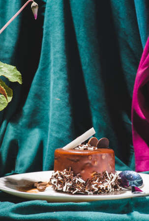 Chocolate spongy brownie cakes with walnuts and melted chocolate topping on a stackの写真素材