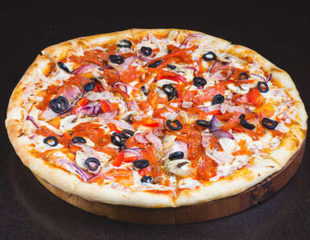 pizza with olives, sausage and bell pepper on a white backgroundの写真素材