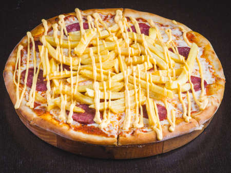 Many kinds of tasty pizza with salami, meat and chicken on light background. Table with many italian homemade pizza. flat lay foodの写真素材