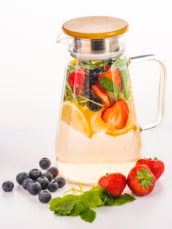 Lemonade or cocktail rhubarb, strawberry, mint, lemon and ice on light blue background. vertical formatの写真素材