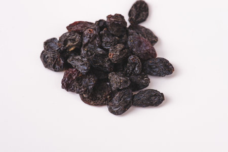 Dried raisins on a white background