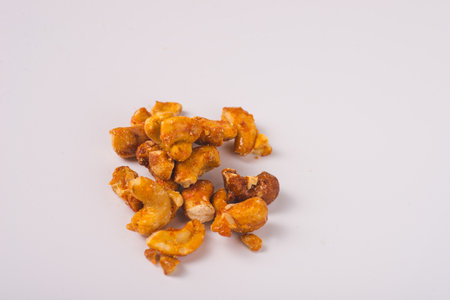 cashew nut in melted caramel isolated on white backgroundの写真素材