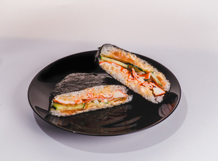 Japanese rice sandwich onigirazu with luncheon meat and vegetables. Healthy dinner recipe and idea. Colorful japan sandwich onigirazuの写真素材