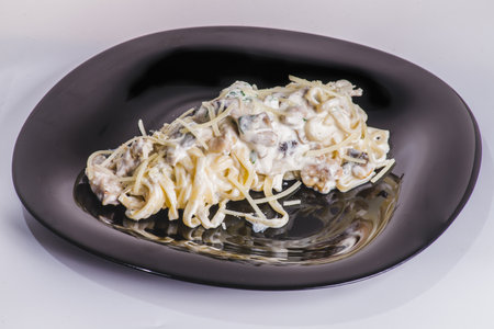 homemade fettuccine pasta with white cream sauce. fettuccine Carbonara made with eggs, hard cheese, cured pork, and black pepper. Italian food.の写真素材