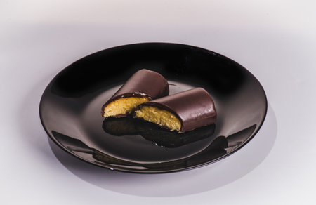 A piece of chocolate cake with mint on the table, close-upの写真素材