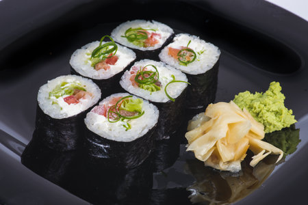 Sushi roll with fried salmon, tomato, cheese, green onionの写真素材