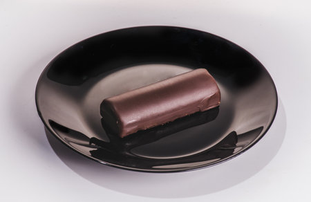 Sweet mini chocolate tarts with pieces of chocolate and mint on a gray background.の写真素材