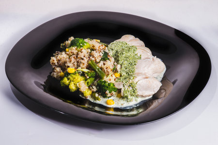 Buddha bowl with kale salad, quinoa, roasted chickpeas, grilled chicken breast, avocado, baked sweet potatoes, leek sprouted seeds, pine nuts, sesame and seeds.の写真素材