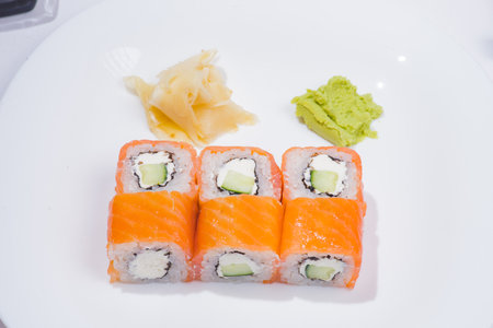 Philadelphia roll classic dark stone on the Board. Salmon, Philadelphia cheese, cucumber, avocado. Japanese sushi. top view.の写真素材