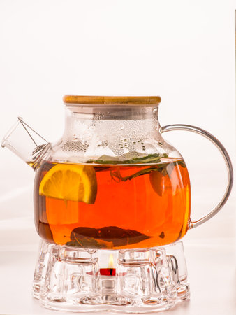 Teapot of red tea and lemon on rustic wooden table. Healthy drink.の写真素材